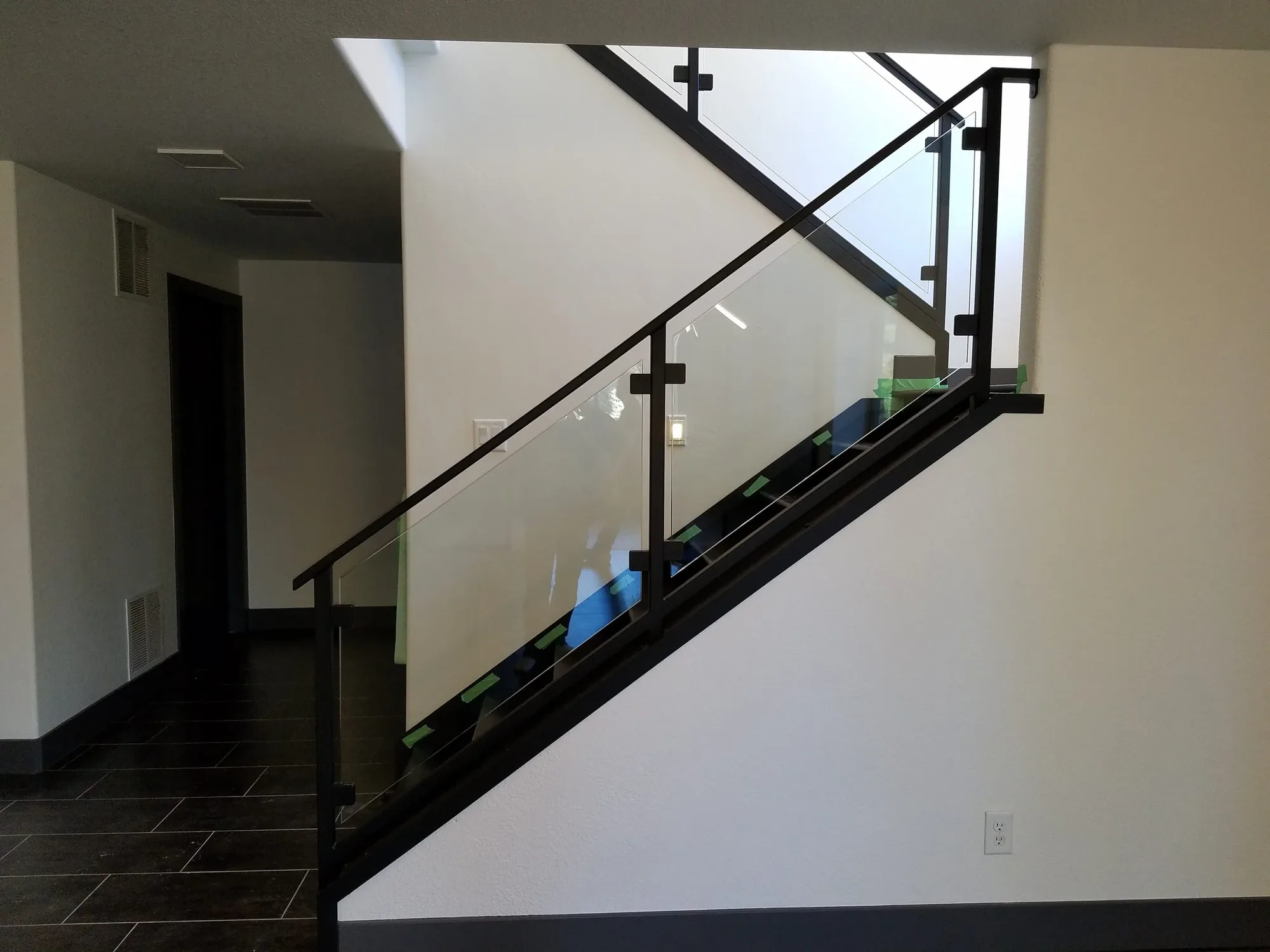 Interior staircase with glass panel railing