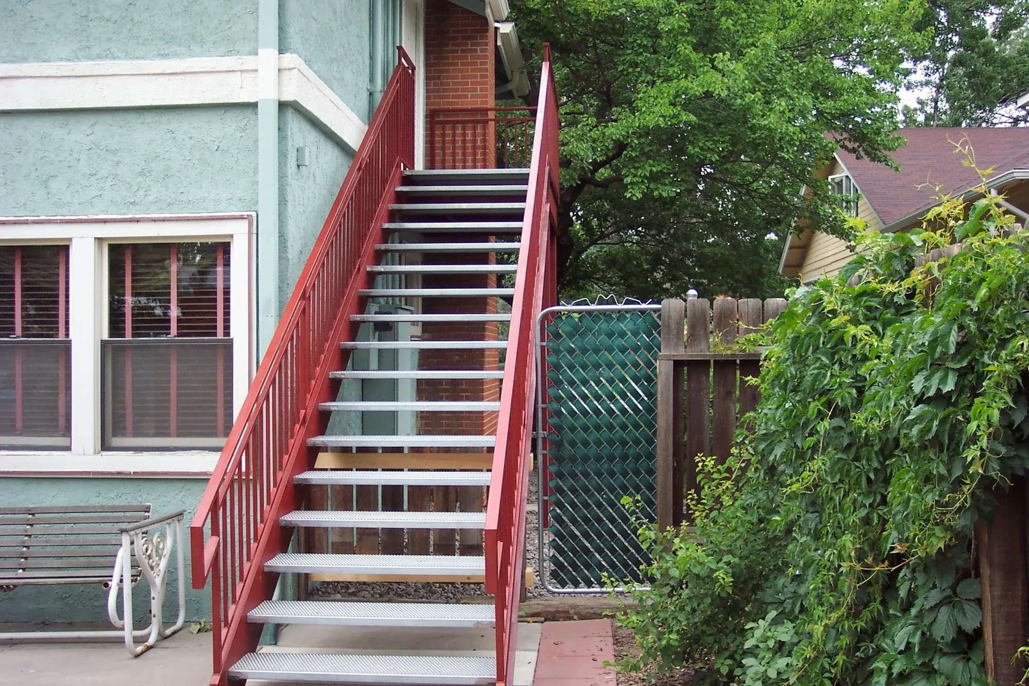 Custom Red Steel Exterior — Staircase