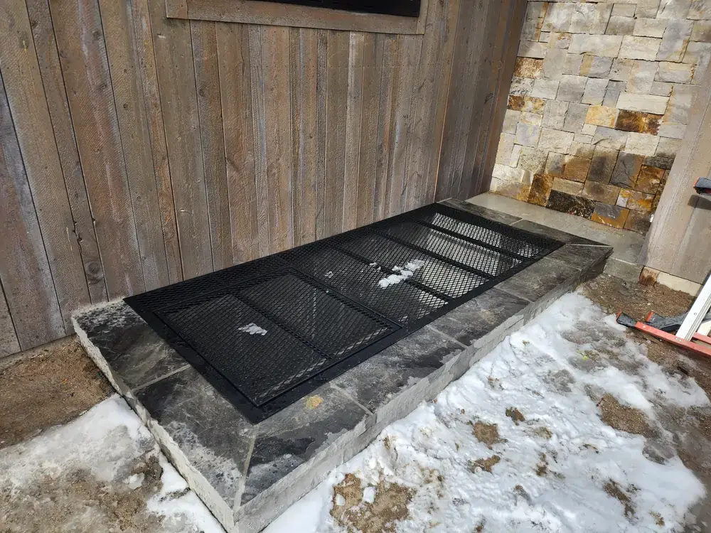 Exterior iron window well guard installation